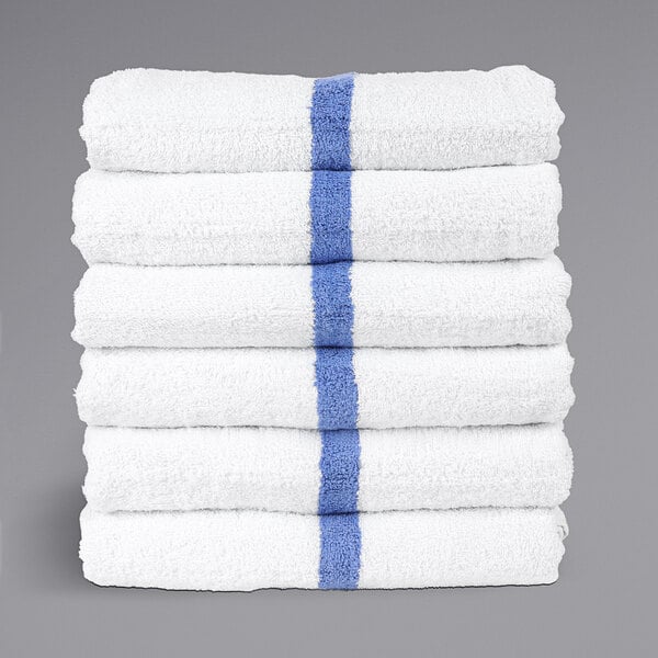 A stack of Monarch Brands white pool towels with blue center stripes.