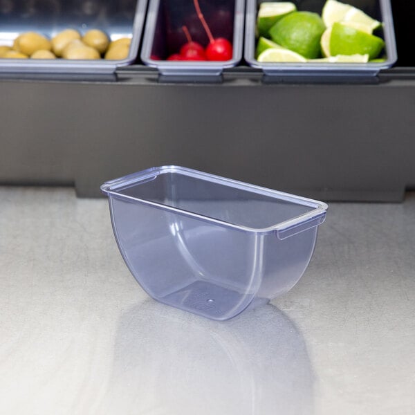 A clear plastic container with a lid on a grey surface.