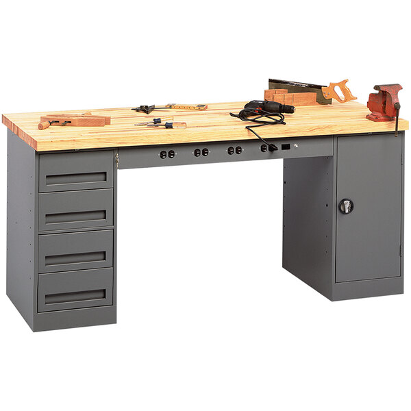 A Tennsco modular workbench with a cabinet and drawers holding tools.