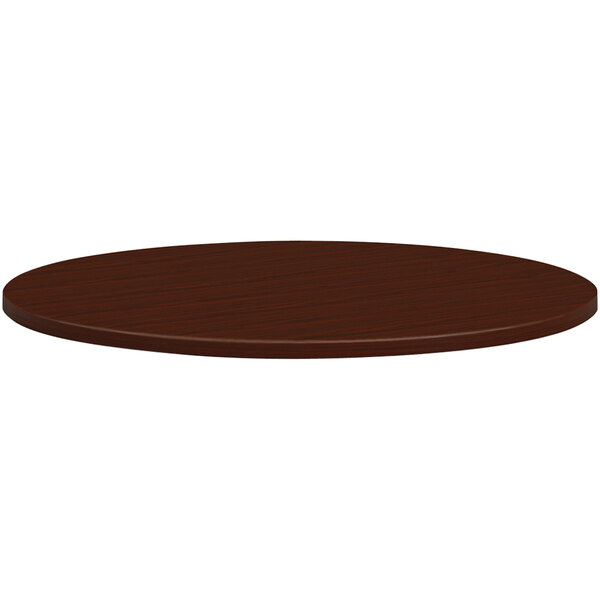 A HON mahogany laminate round conference table top.