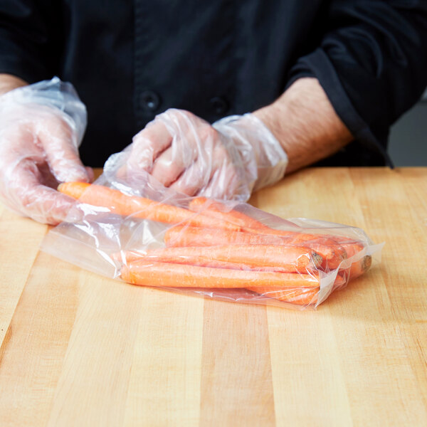 A person in a black coat holding a LK Packaging plastic bag of carrots.