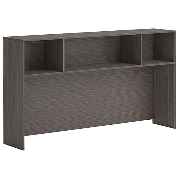 A brown laminate desk hutch with shelves.