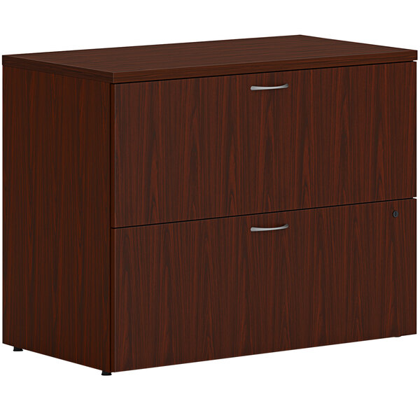 A HON traditional mahogany lateral file cabinet with two drawers.