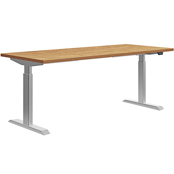 A HON Coze Coordinate desk with a natural recon wooden top and silver metal legs.