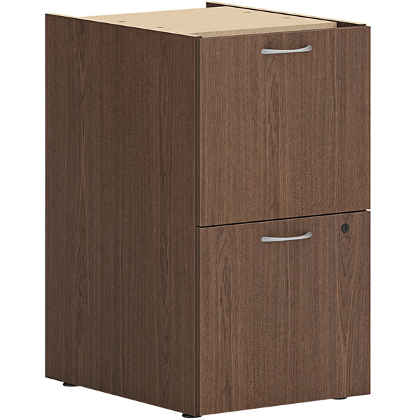 A brown wooden HON file cabinet pedestal with two drawers and silver handles.