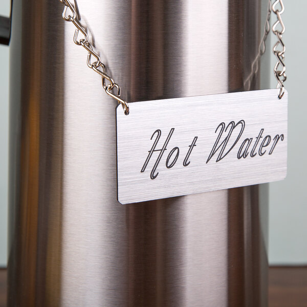 A Cal-Mil chain sign on a hot water urn.