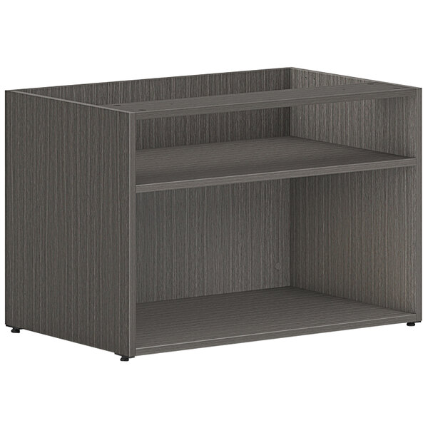A black HON Mod low open storage credenza with shelves.