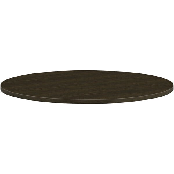 A HON Java Oak laminate round conference table top.