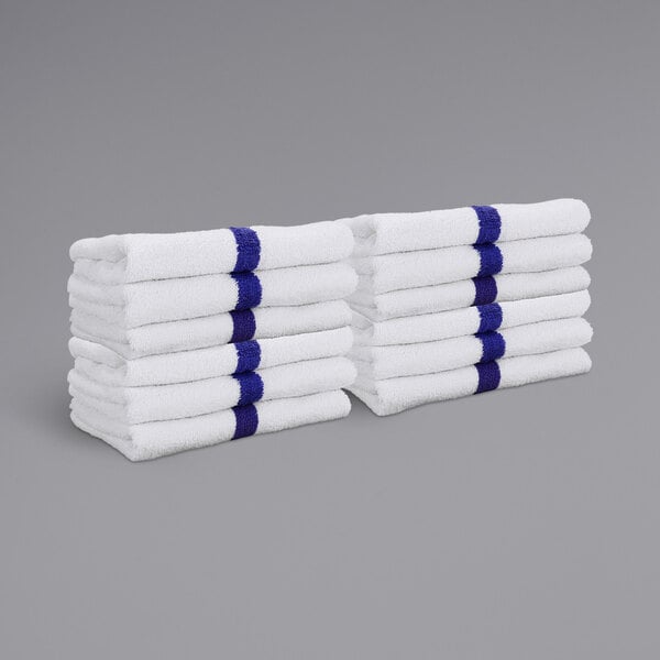 A stack of white towels with blue stripes.