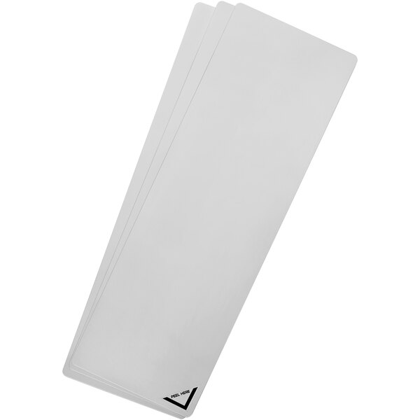A stack of white papers with a silver Deflecto acrylic craft sheet on top.
