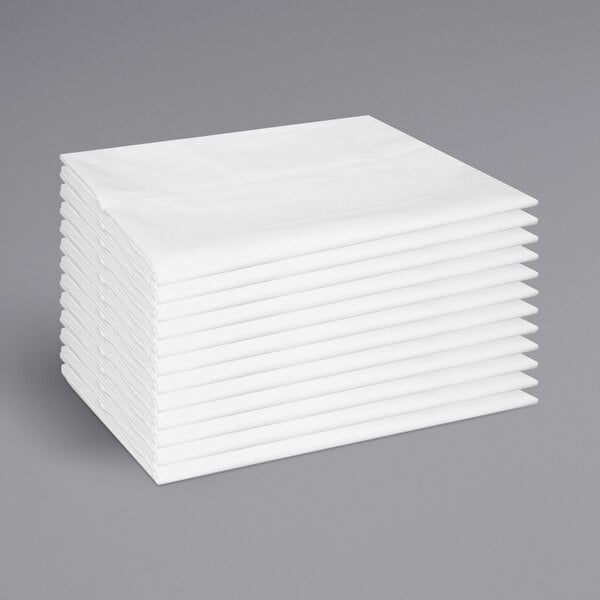 A stack of white Monarch Brands cotton/polyester pillowcases.