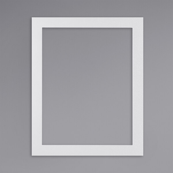 A white rectangular sign holder with a white border on a grey wall.