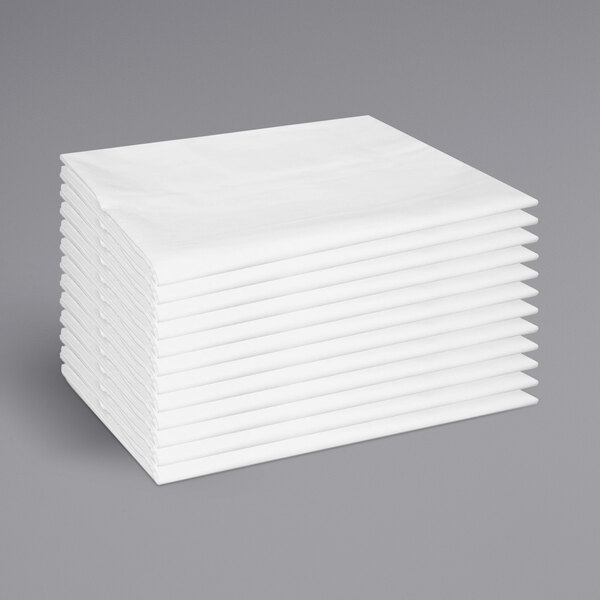 A stack of white Monarch Brands pillow cases.