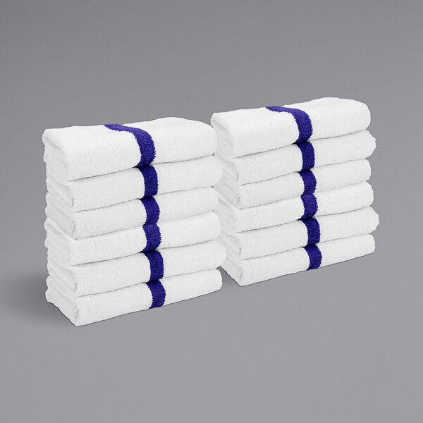 A stack of white towels with blue stripes.