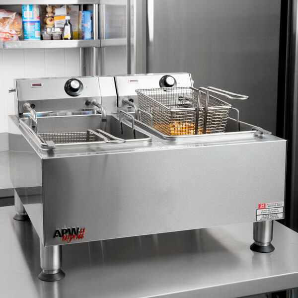 An APW Wyott commercial countertop deep fryer with two baskets.