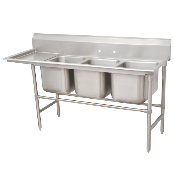 A stainless steel Advance Tabco three compartment sink with left drainboard.