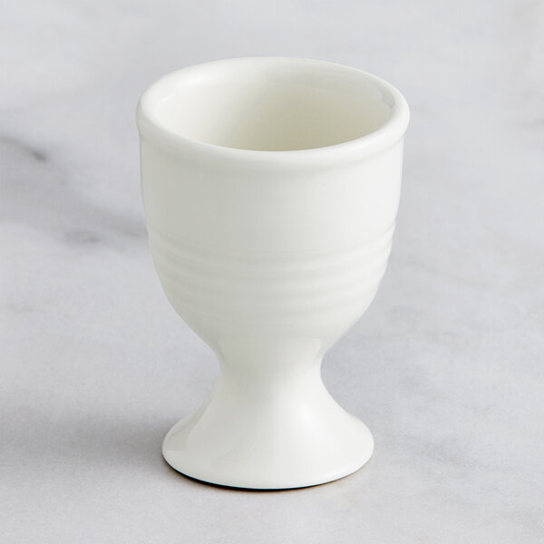 A RAK Porcelain ivory egg cup on a white surface.