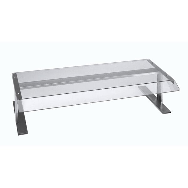 A white rectangular APW Wyott sneeze guard with a metal frame on a table.