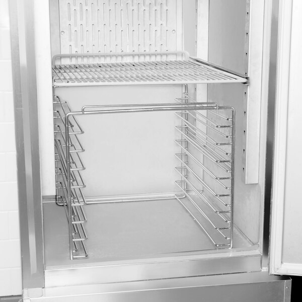 A Delfield stainless steel tray rack in a refrigerator.