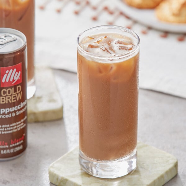 A close up of a can of illy Cold Brew Latte Cappuccino with brown liquid inside.