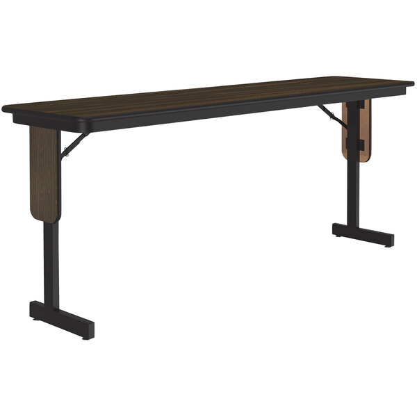 A Correll rectangular seminar table with walnut thermal-fused laminate top and black panel legs.