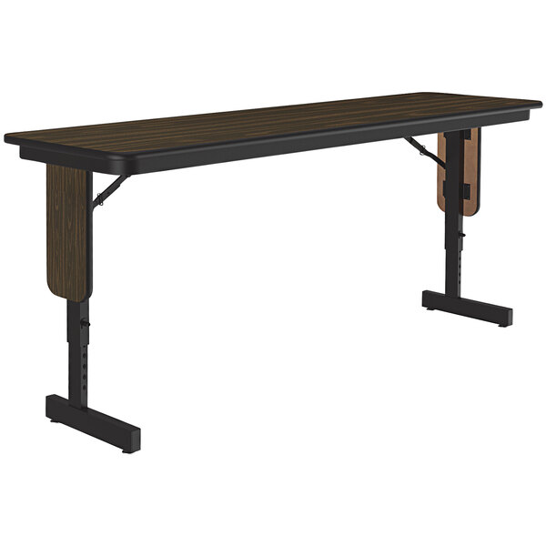A Correll rectangular seminar table with walnut top and black panel legs.