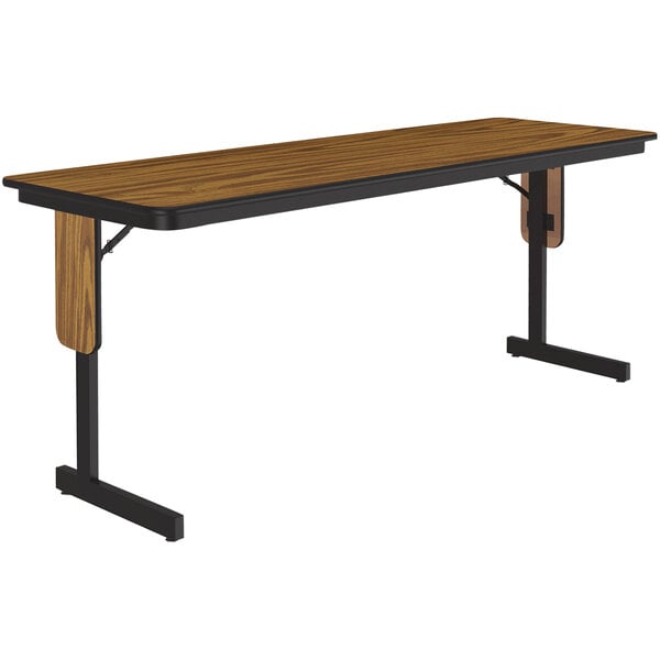 A rectangular wooden seminar table with black panel legs and trim.