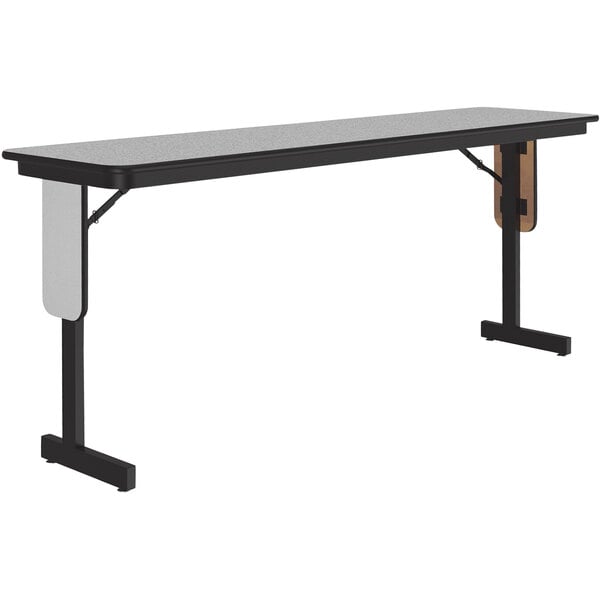A Correll seminar table with a gray granite surface and panel legs.