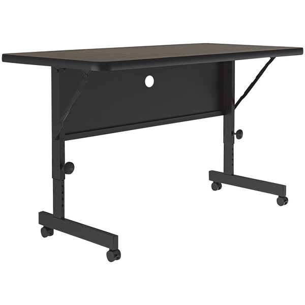 A black rectangular Correll flip top table with wheels.