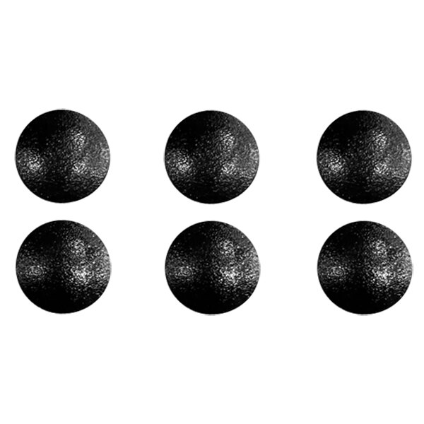 A close-up of several black circles with white spots.