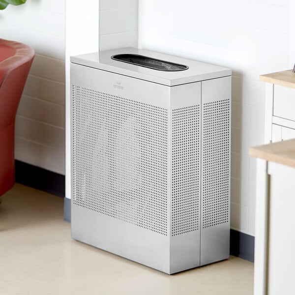 A rectangular stainless steel waste receptacle with a black top sitting on a white floor.