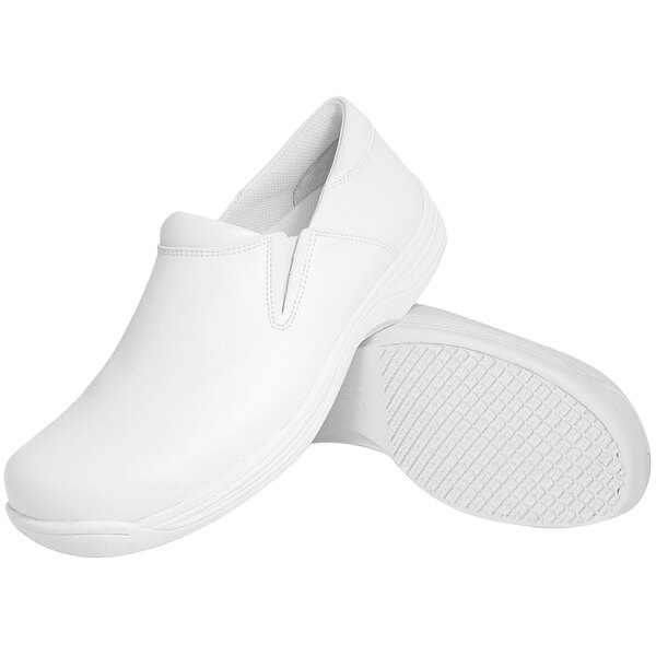 A pair of white Genuine Grip non-slip slip-on shoes.