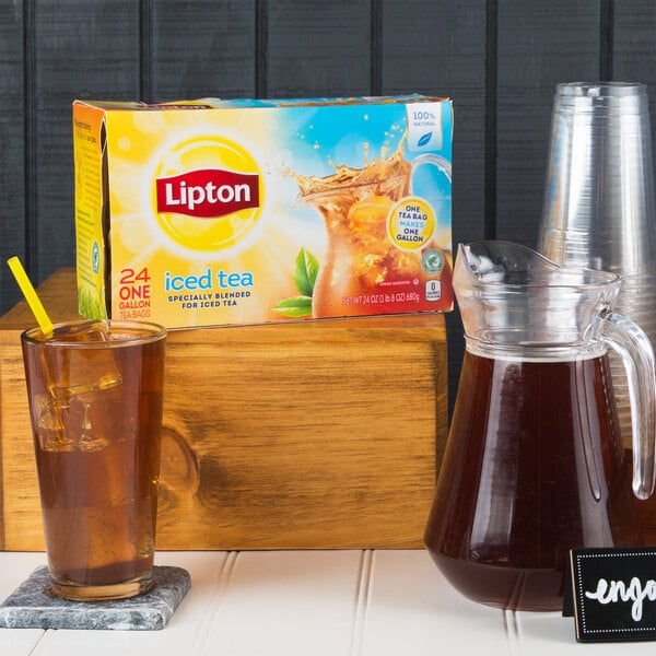A box of Lipton iced tea filter bags next to a pitcher of tea.