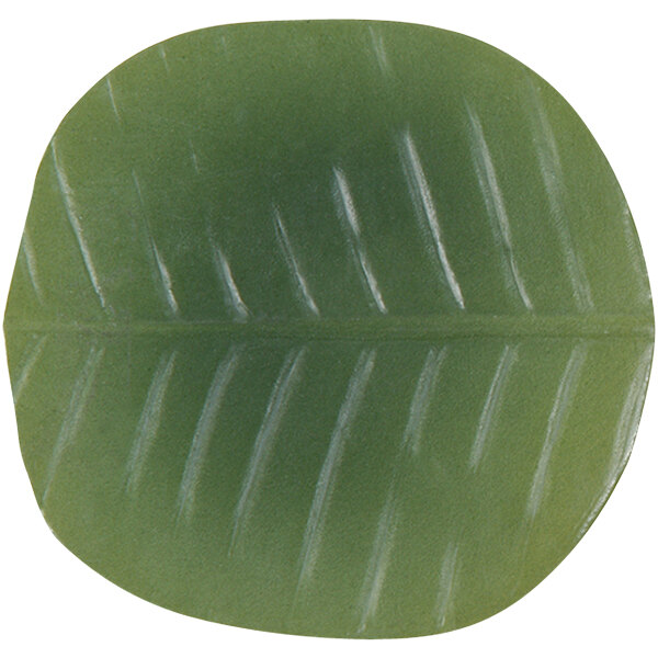 A close-up of a green leaf shaped coaster.