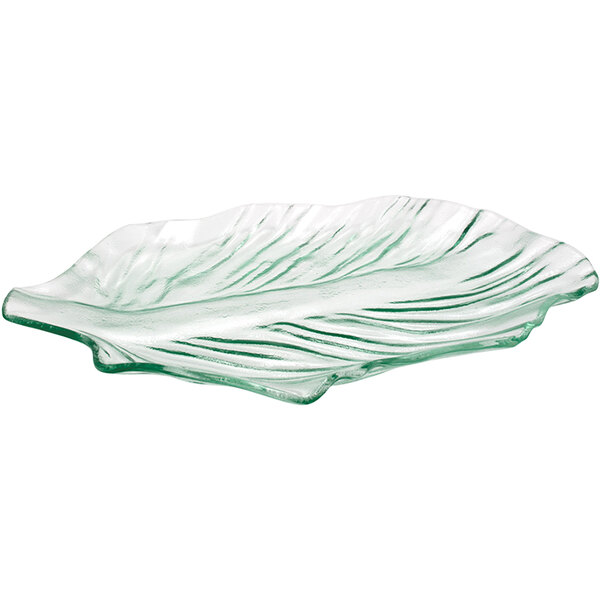 A clear glass leaf-shaped platter with a leaf pattern.