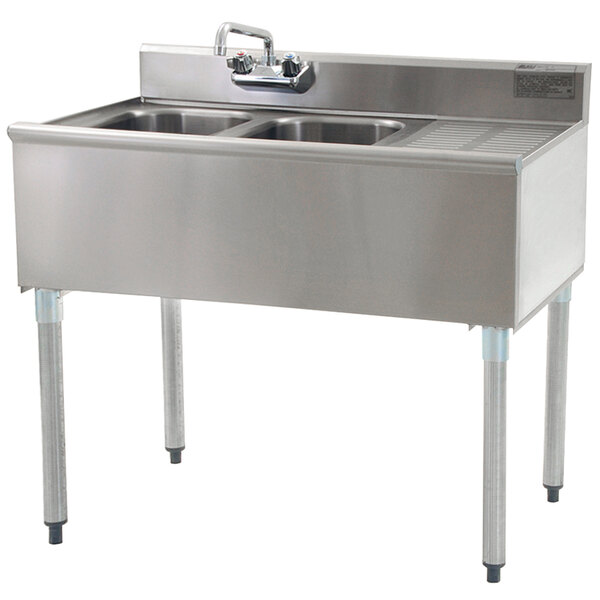 A stainless steel Eagle Group underbar sink with two bowls and a right drainboard with splash mount faucet.
