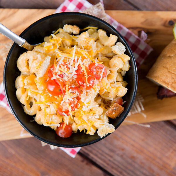 A bowl of Regal elbow macaroni pasta with tomatoes and bacon.