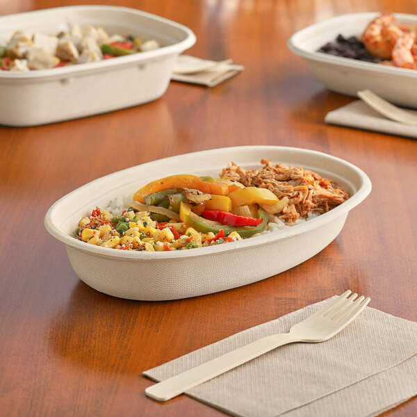 World Centric compostable fiber burrito bowls filled with food on a table.