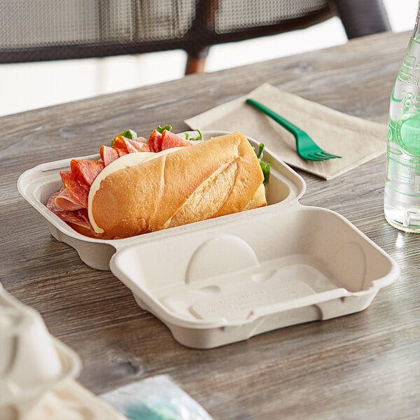 A sandwich in a World Centric compostable hoagie box on a table.