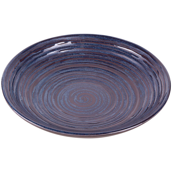 An Elite Global Solutions blue and brown melamine bowl with swirls on a table.