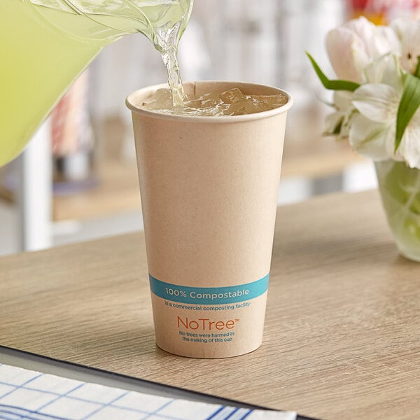 A person pouring a drink into a World Centric NoTree paper cold cup.