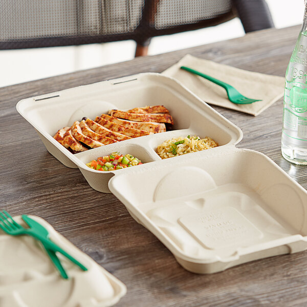 A World Centric compostable 3-compartment container with food inside on a table.