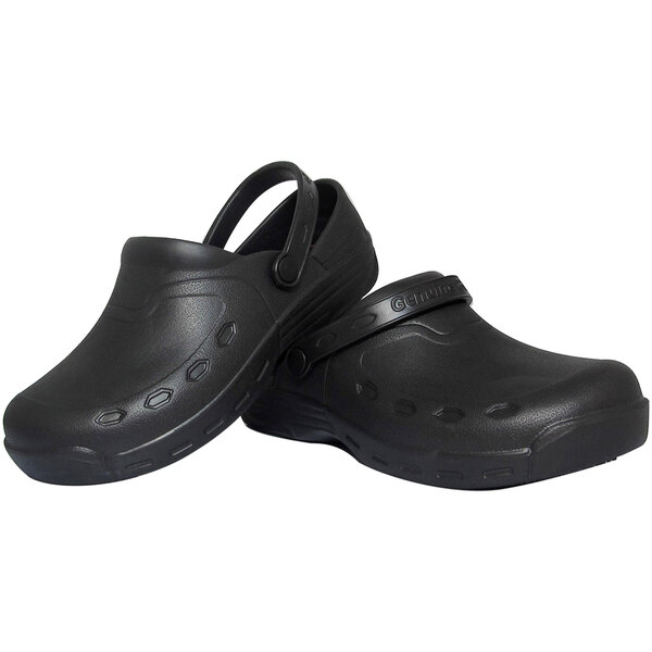 A pair of Genuine Grip black non-slip clogs with straps on the side.
