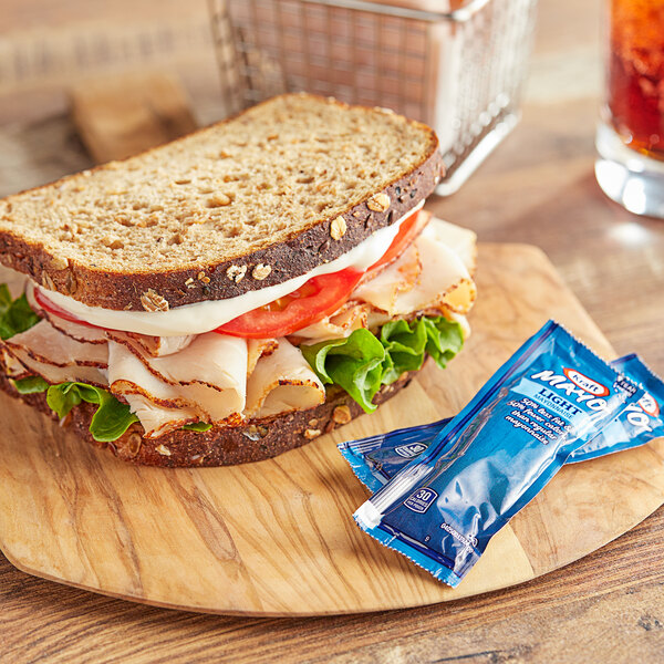 A sandwich on a wooden board with a drink.