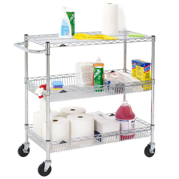 A Metro Super Erecta three tier chrome utility cart with cleaning supplies on it.
