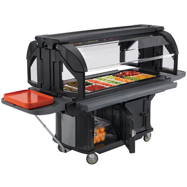 A black Cambro Versa Ultra food cart on a table with a tray of vegetables.