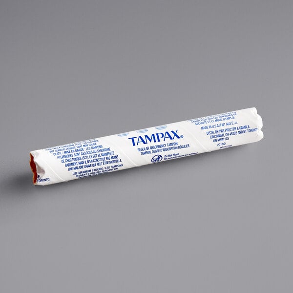 A white and blue Tampax tampon in a blue paper wrapper with the word Tampax.