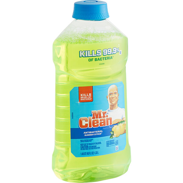A bottle of Mr. Clean Antibacterial Cleaner with green liquid on a grocery store shelf.