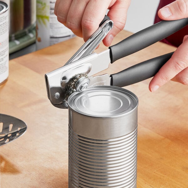 A person using the Swing-A-Way Easy-Crank can opener to open a can.