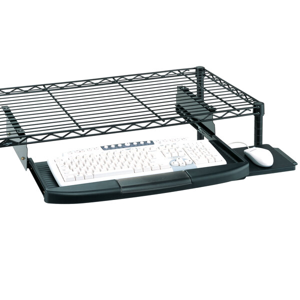 A Metro keyboard tray holding a keyboard and mouse on a wire shelf.
